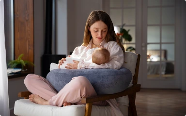 woman-using-nursing-pillow-home-newborn-baby 1